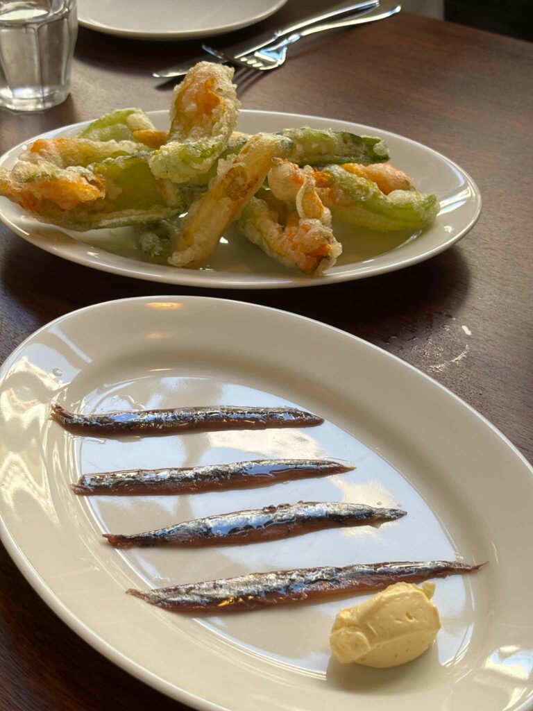 Sardines in the foreground and zucchini flower tempura at Bar Super in Barcelona