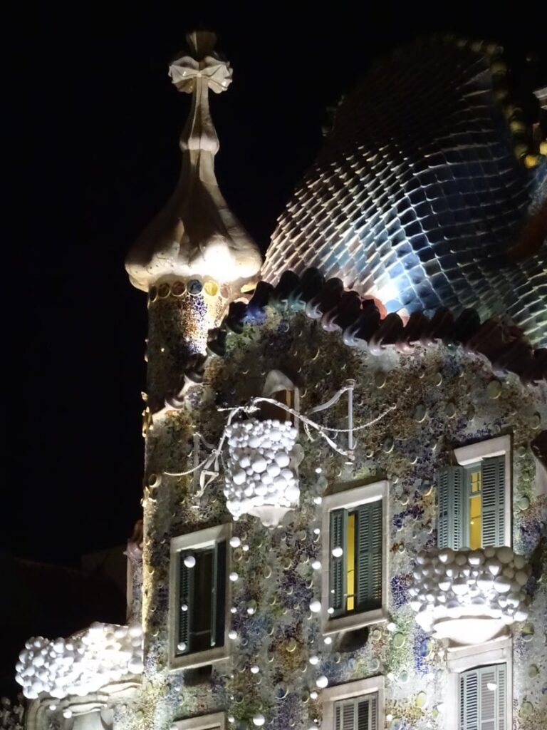 Top floors of Casa Battle in Barcelona at night with Christmas decorations