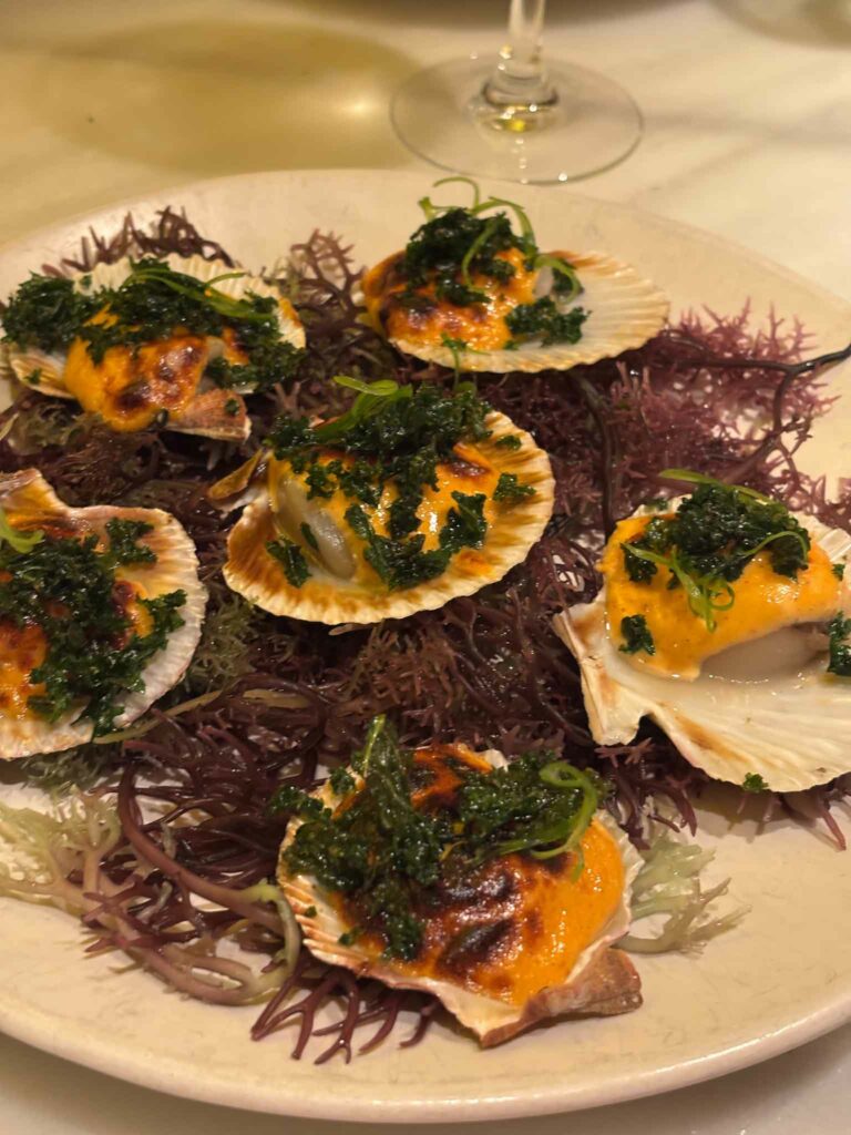 Scallops in the shell on a bed of seaweed at Fismuler restaurant in Barcelona
