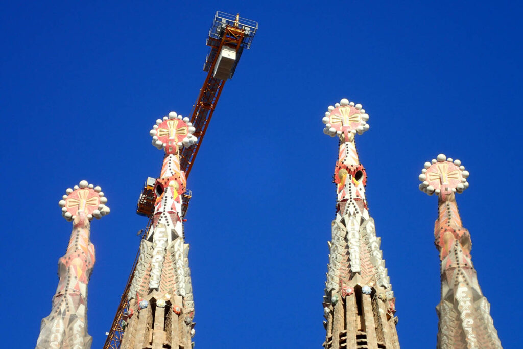 Spires on top od Sagrada Familia in Barcelona with a crane in the background