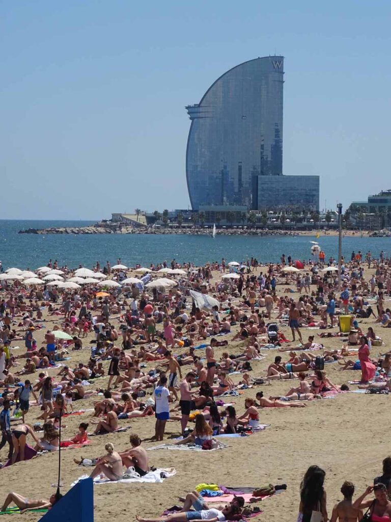 Crowds on Barceloneta beach with the W Hotel in the background